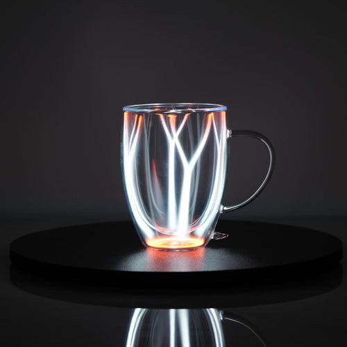 Plasma Mug by Astro Labs glowing with white plasma filaments inside a clear double-walled glass mug on a powered base.